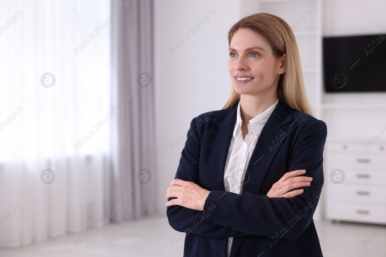 Photo of Happy real estate agent in new apartment. Space for text