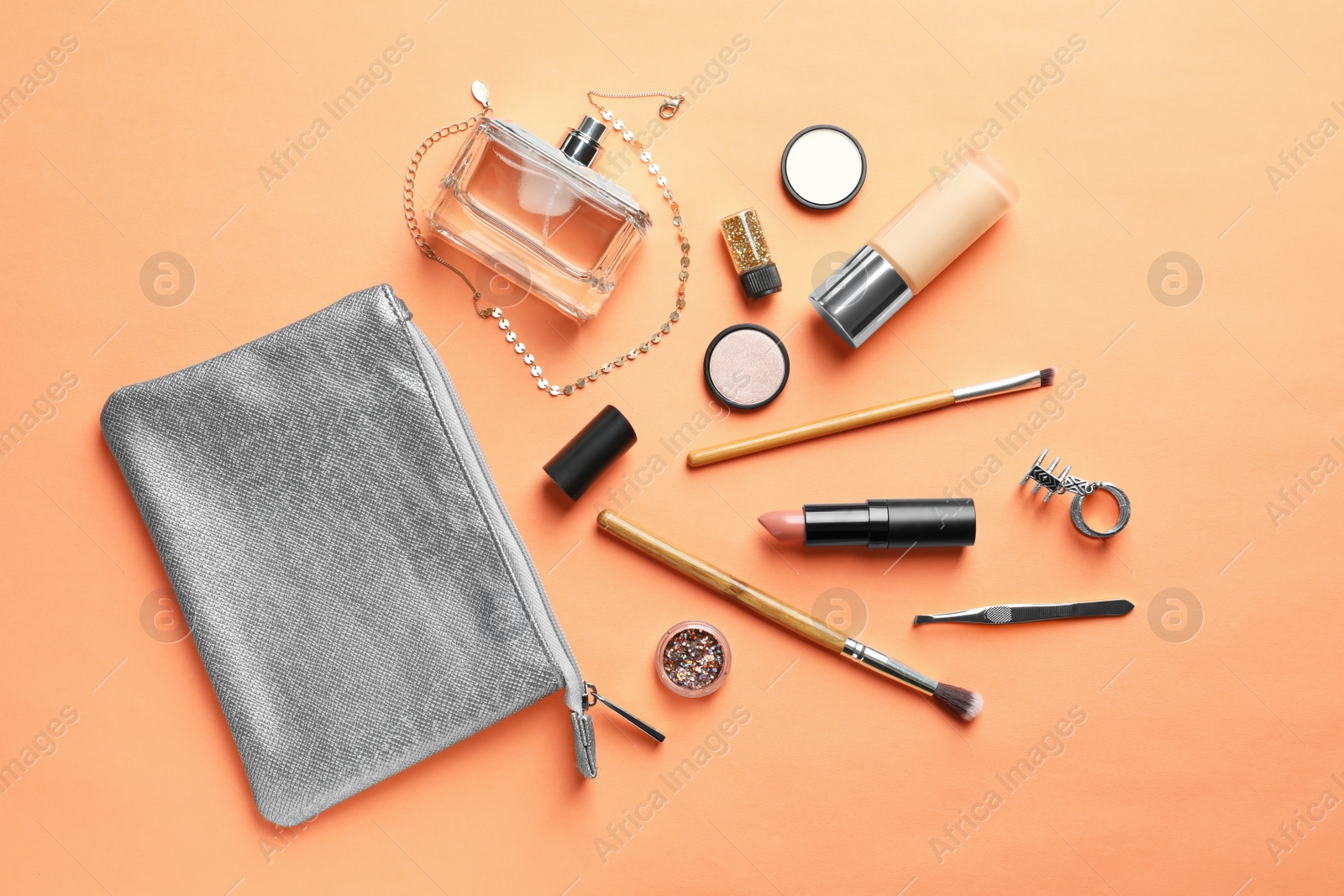 Photo of Makeup products with cosmetic bag on color background