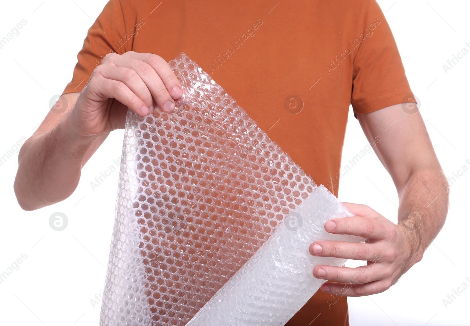 Photo of Man holding roll of bubble wrap on white background, closeup. Stress relief