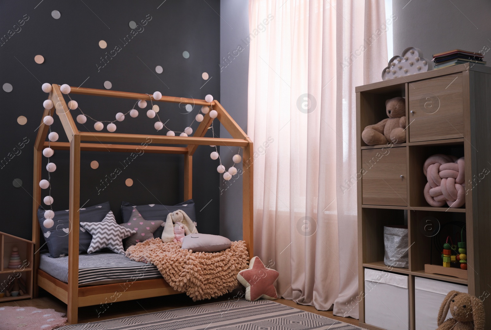 Photo of Stylish child room interior with comfortable bed