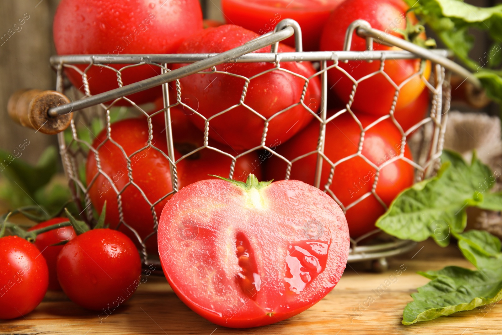 Photo of Fresh ripe tomatoes with leaves on wooden table