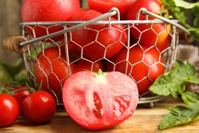 Fresh ripe tomatoes with leaves on wooden table