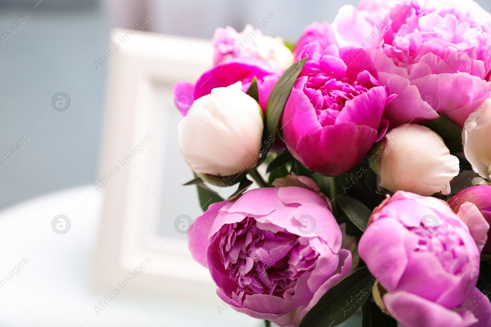 Photo of Bouquet of beautiful peonies in room, closeup. Space for text