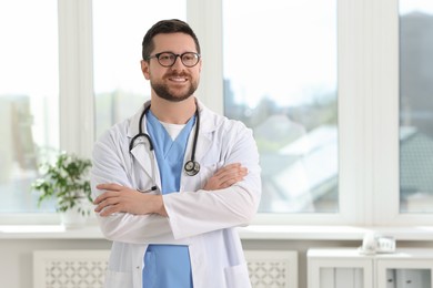 Photo of Portrait of smiling doctor with stethoscope in hospital. Space for text