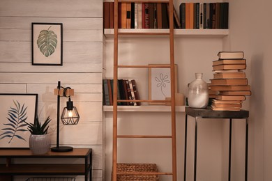Home library interior with modern furniture and collection of different books on shelves
