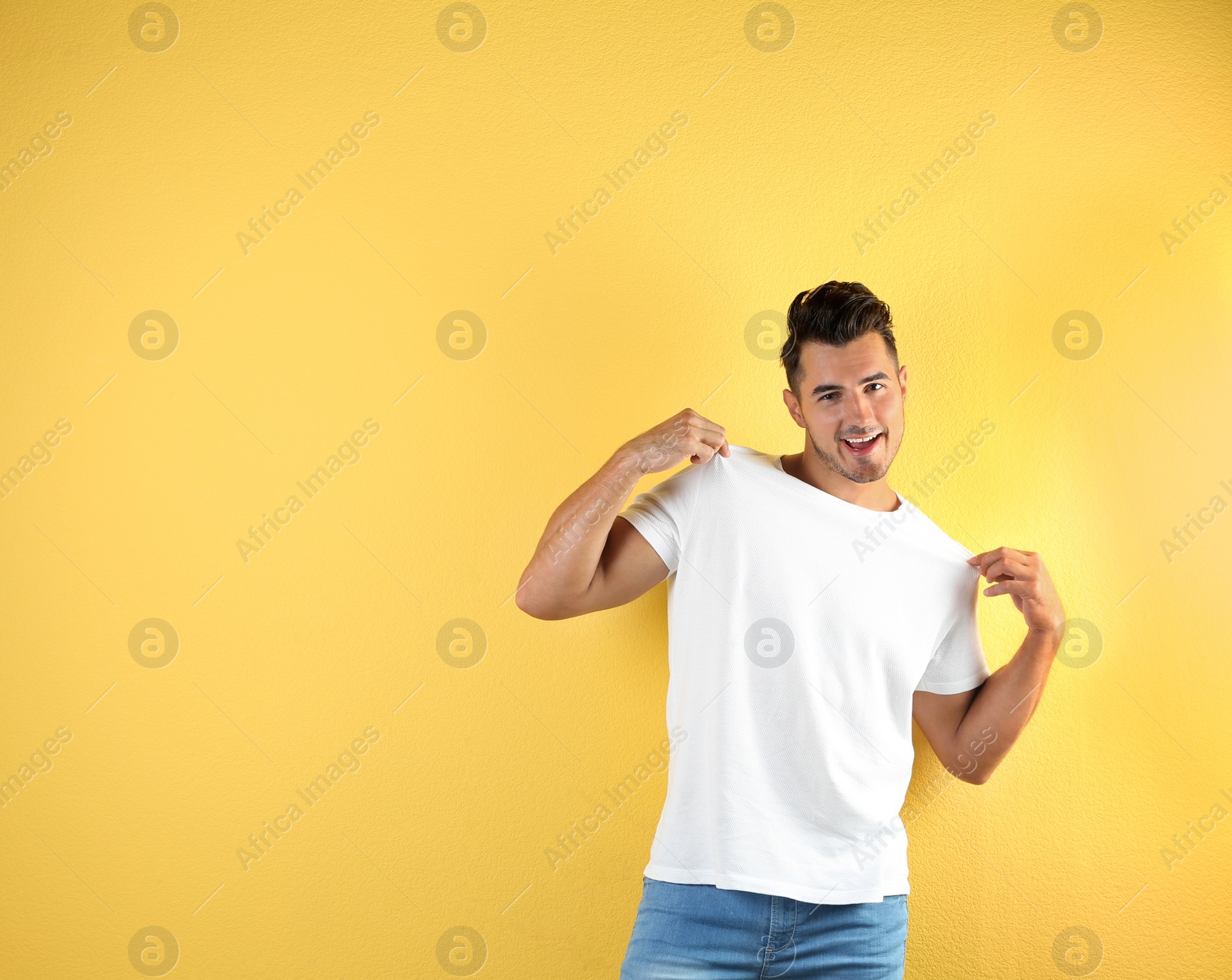 Photo of Young man in t-shirt on color background. Mockup for design