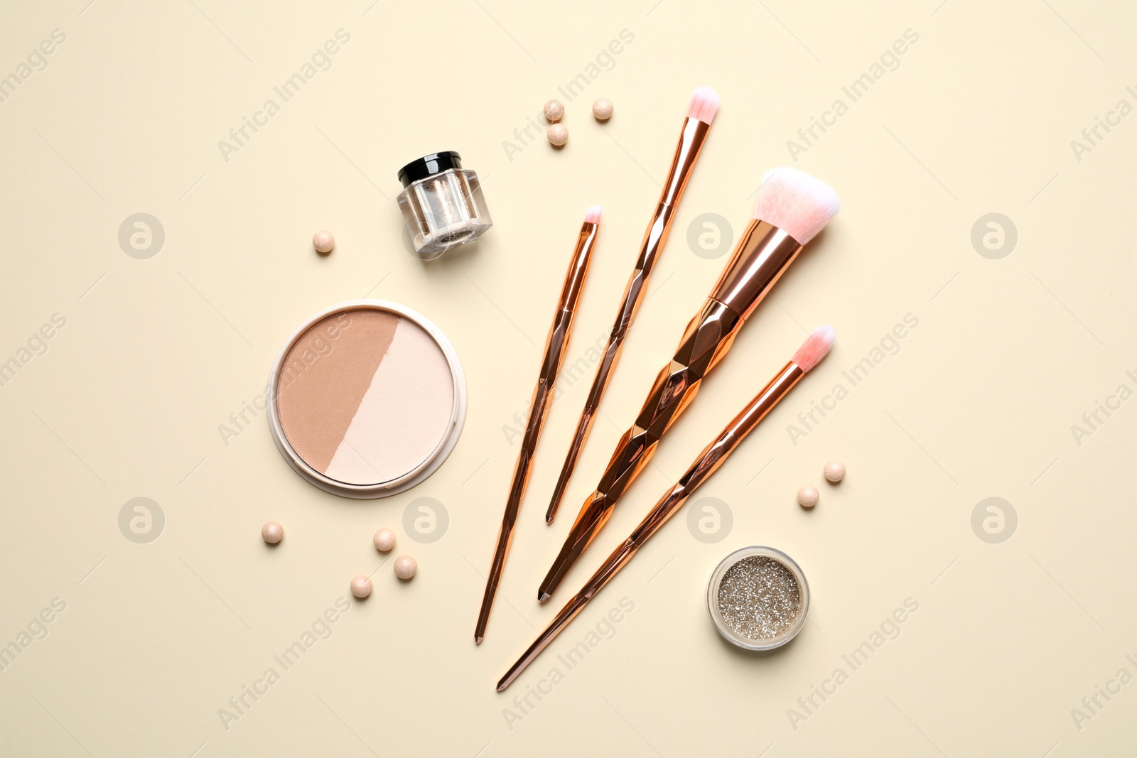 Photo of Flat lay composition with makeup brushes on beige background
