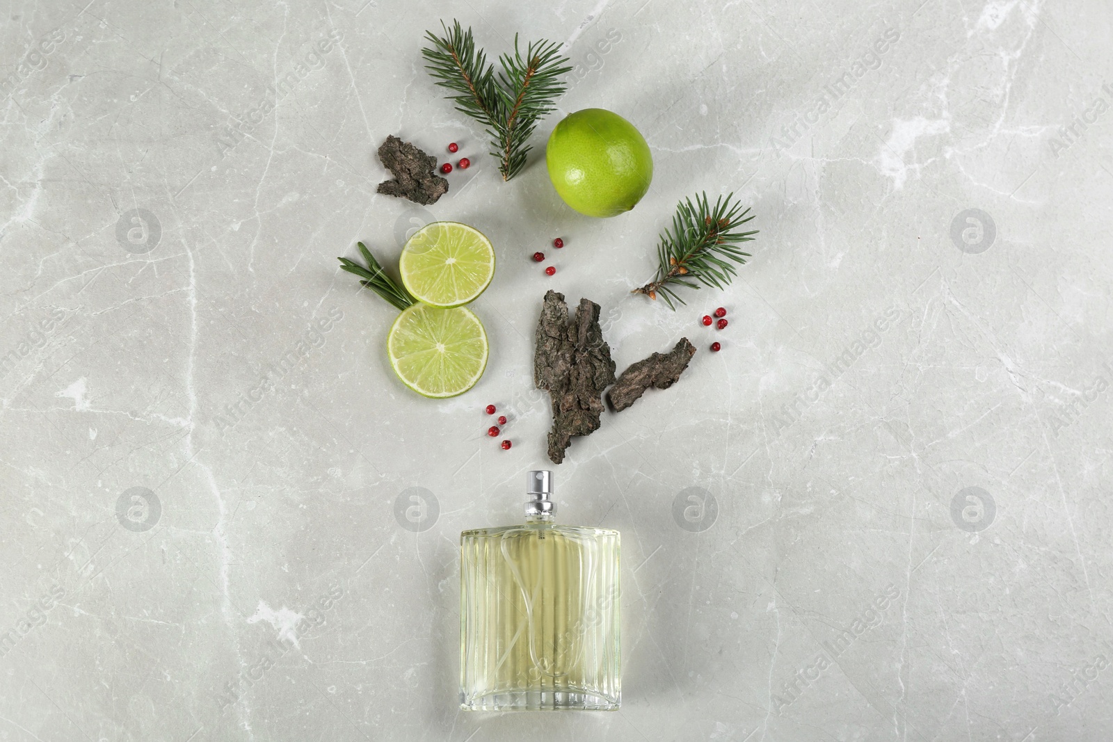 Photo of Flat lay composition with bottle of perfume on marble background