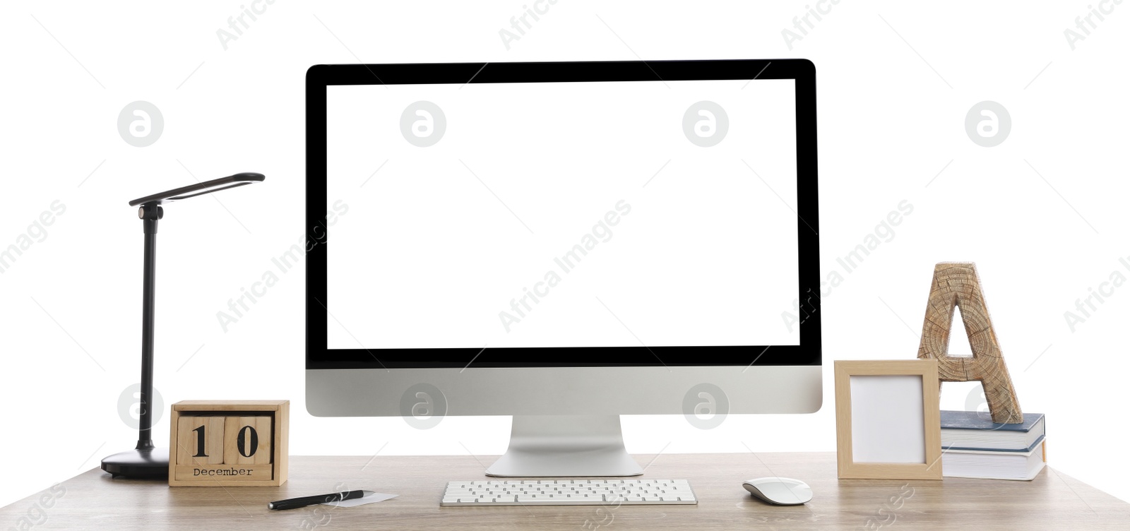 Photo of Wooden table with modern computer, decor and stationery on white background