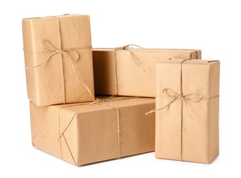 Photo of Parcels wrapped with kraft paper and twine on white background