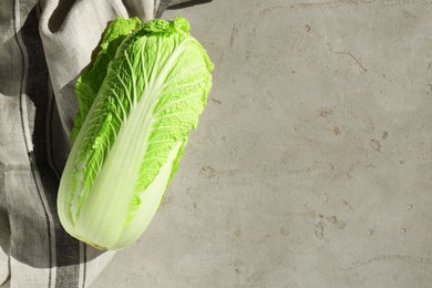 Photo of Fresh ripe Chinese cabbage on gray textured table, top view. Space for text