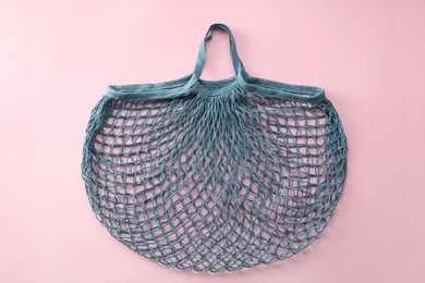 Photo of Blue string bag on pink background, top view