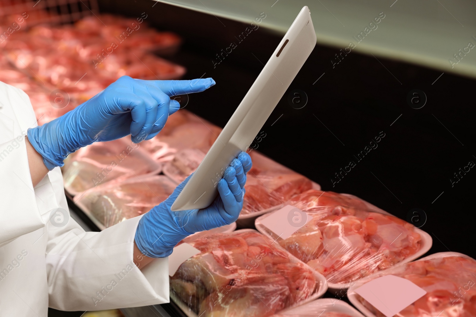 Image of Food quality control specialist examining meat in supermarket, closeup