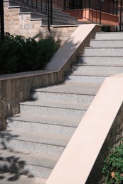 Photo of View of beautiful grey concrete stairs near plants outdoors