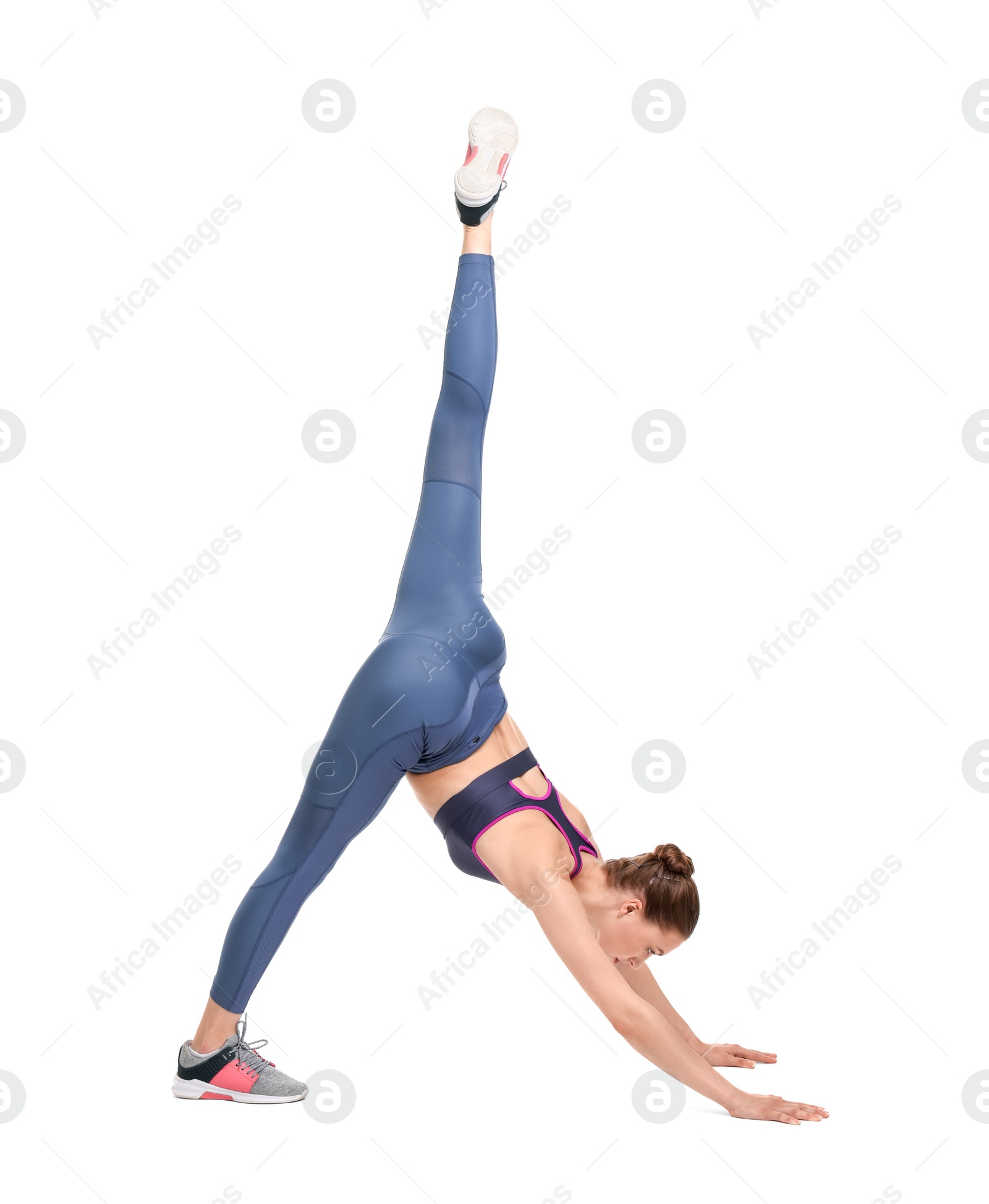 Photo of Yoga workout. Young woman stretching on white background