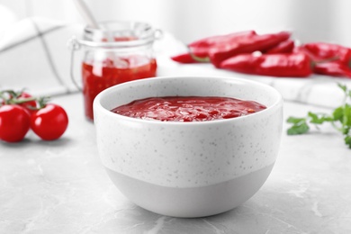 Photo of Bowl of hot chili sauce on light table