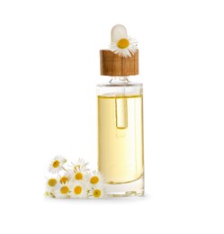 Photo of Bottle of chamomile essential oil and flowers on white background