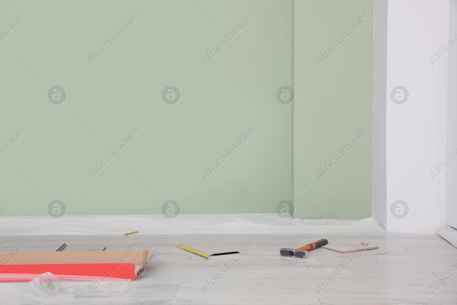 Photo of Light room with unfinished laminate flooring and different tools