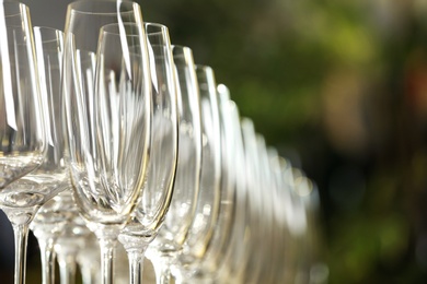 Photo of Set of empty glasses on blurred background, closeup