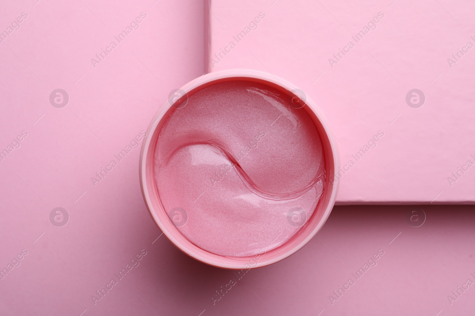 Photo of Package of under eye patches on pink background, top view. Cosmetic product