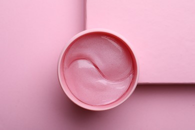 Photo of Package of under eye patches on pink background, top view. Cosmetic product
