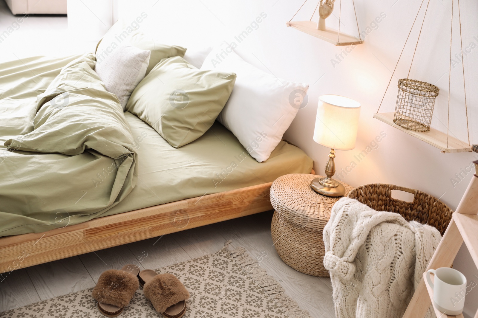 Photo of Comfortable bed with olive green linen in modern room interior