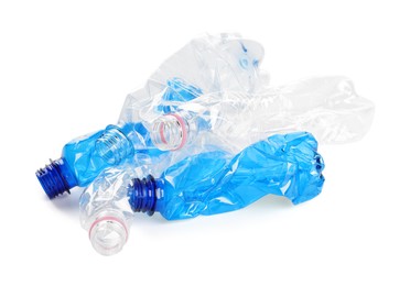 Photo of Crumpled disposable plastic bottles on white background