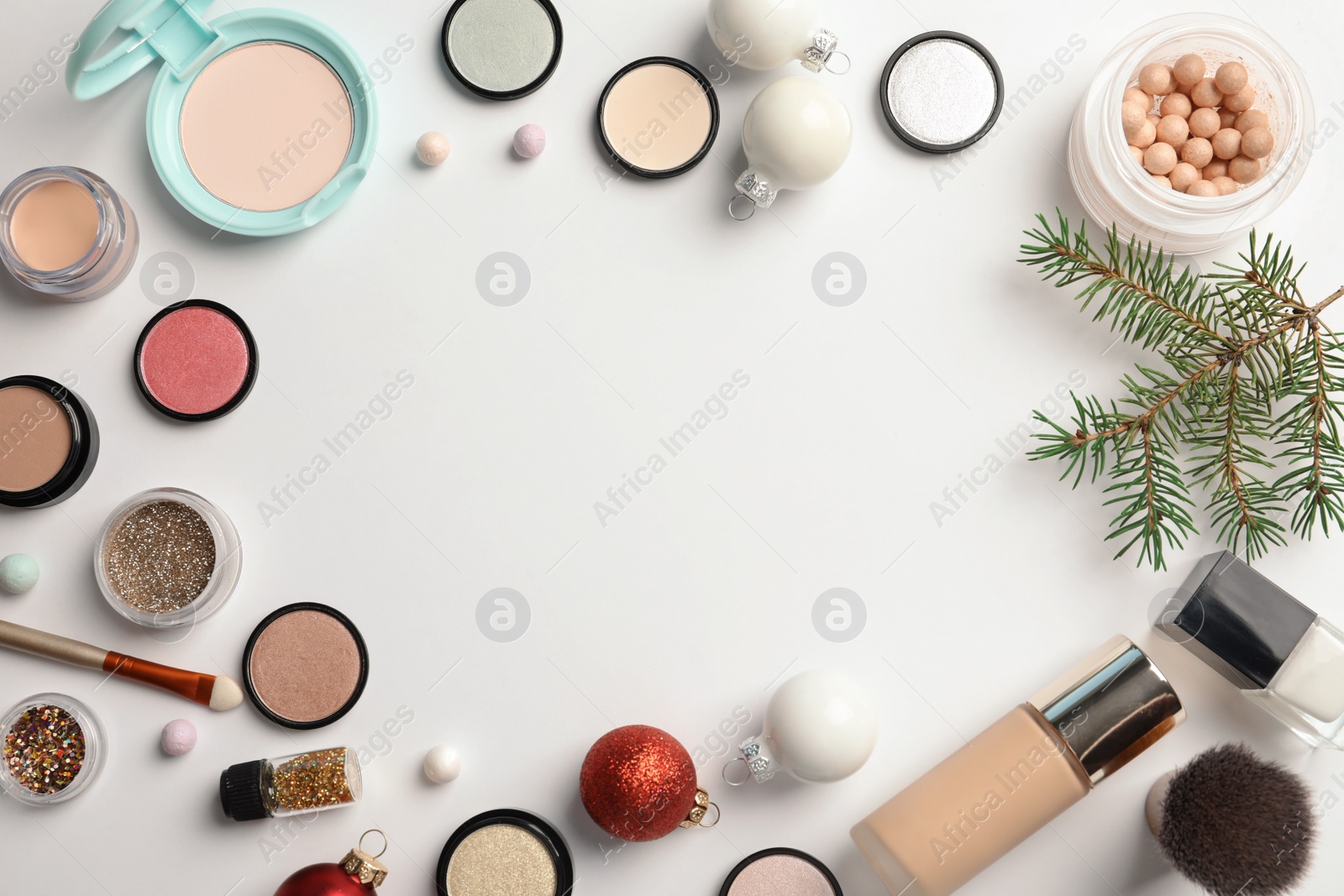 Photo of Flat lay composition with makeup products and Christmas decor on white background. Space for text