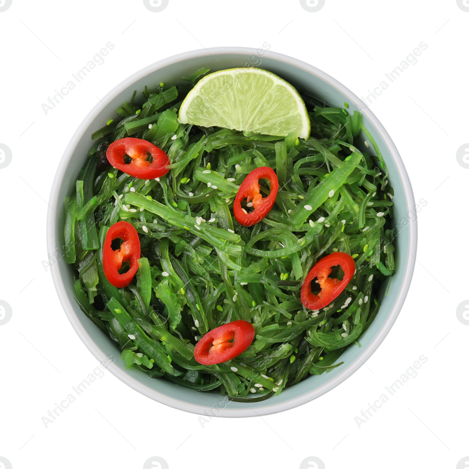 Photo of Tasty seaweed salad in bowl isolated on white, top view