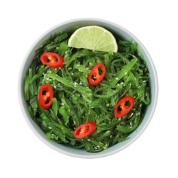Photo of Tasty seaweed salad in bowl isolated on white, top view