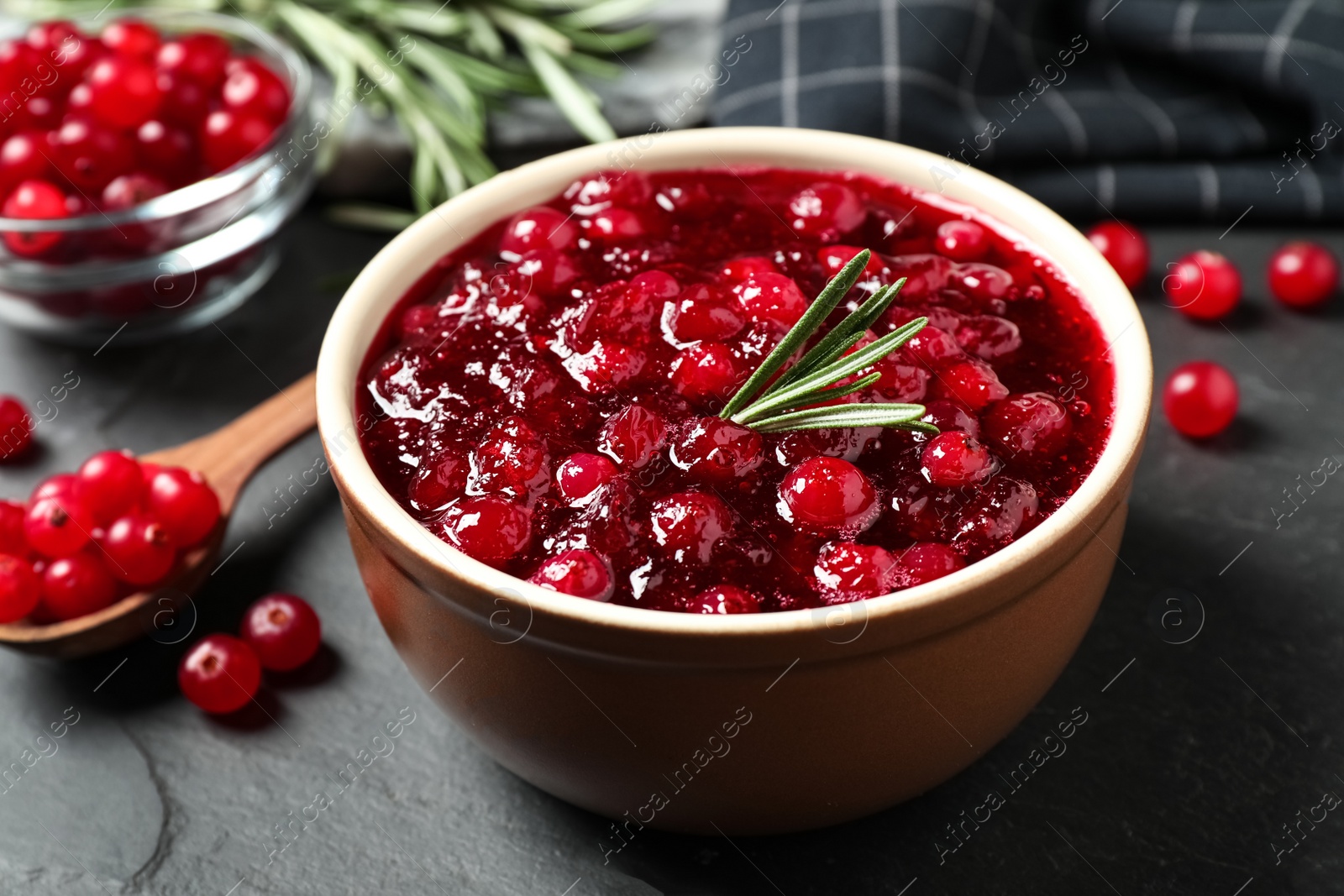 Photo of Cranberry sauce in bowl on dark grey table