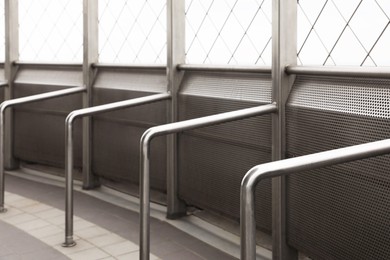 Photo of Enclosed observation deck equipped with metal handrails, closeup