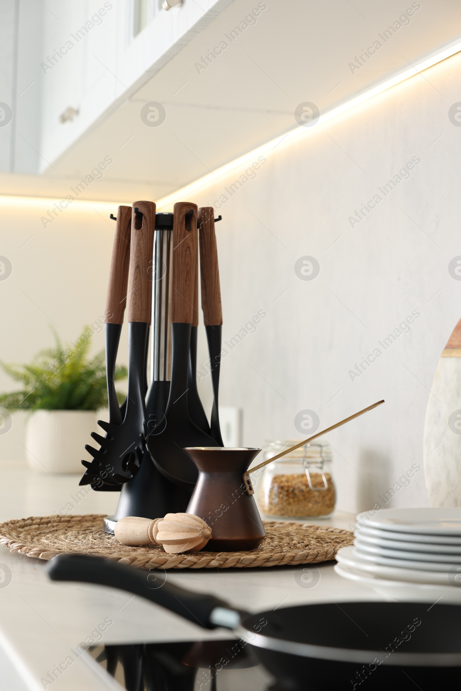 Photo of Set of different utensils and dishes on countertop in kitchen