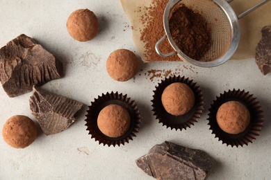 Photo of Flat lay composition with tasty raw chocolate truffles on light background