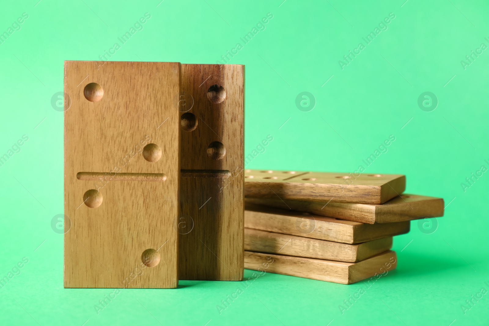 Photo of Domino tiles with pips on green background