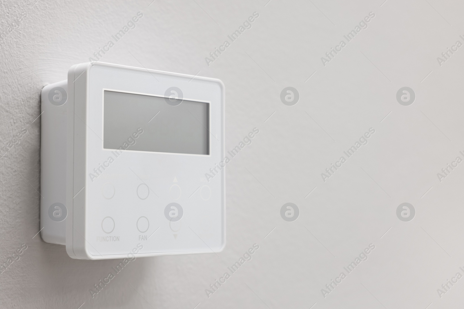 Photo of One thermostat on white wall, space for text. Smart home system