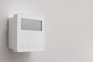 Photo of One thermostat on white wall, space for text. Smart home system
