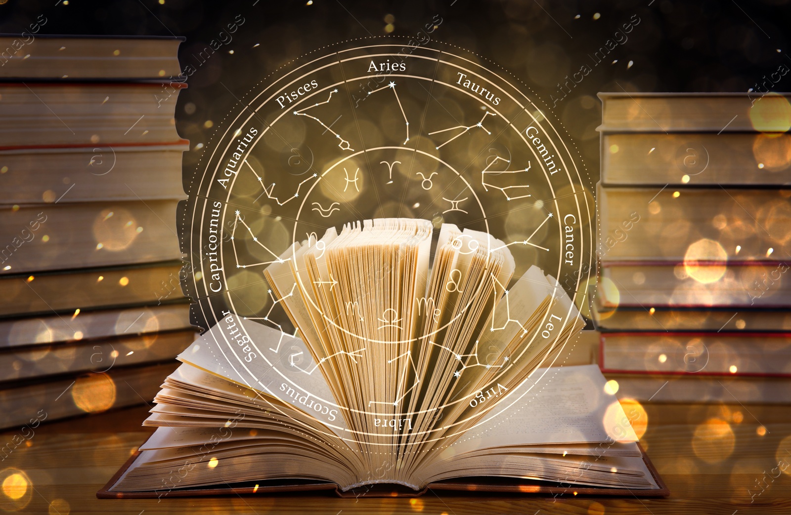 Image of Open book on wooden table and illustration of zodiac wheel with astrological signs