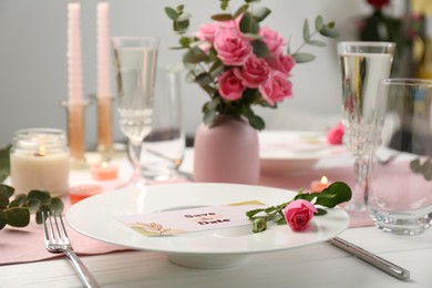 Romantic table setting with flowers and candles