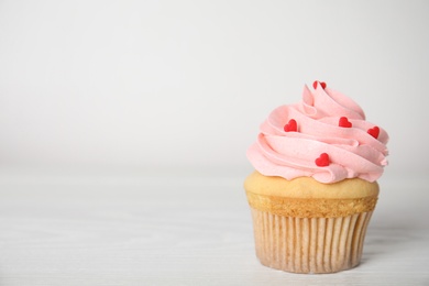 Tasty sweet cupcake on white table, space for text. Happy Valentine's Day