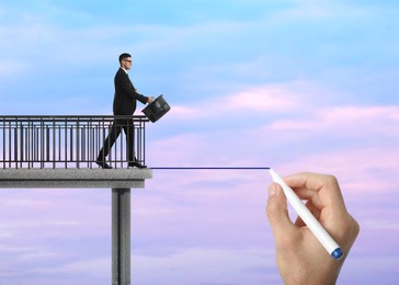 Image of Support or partnership concept. Man drawing bridge to help businessman walk forward
