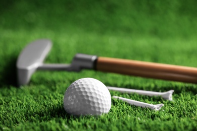 Set of golf equipment on green artificial grass