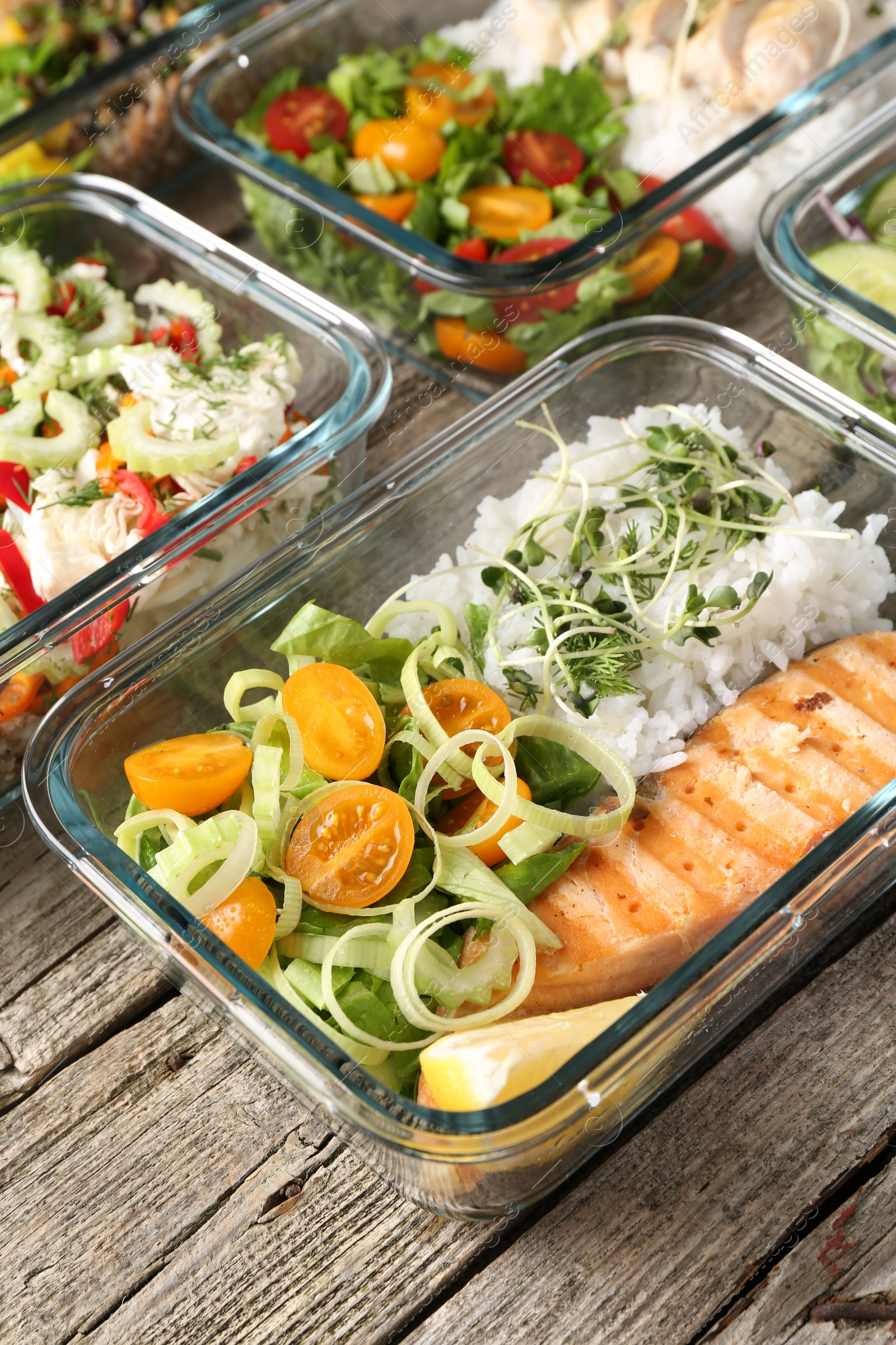 Photo of Healthy meal. Containers with different products on wooden table