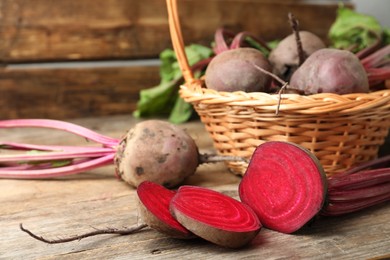 Photo of Cut raw ripe beet on wooden table