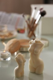 Beautiful body shaped candles on dressing table indoors, space for text