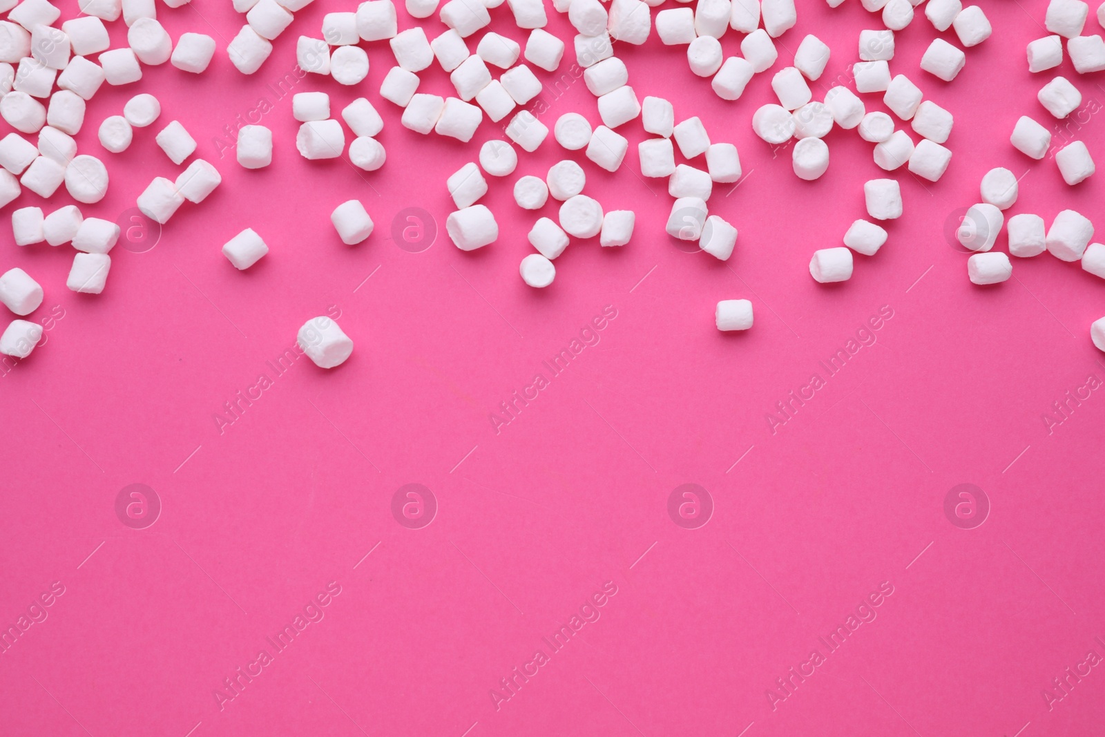 Photo of Delicious marshmallows on pink background, flat lay. Space for text