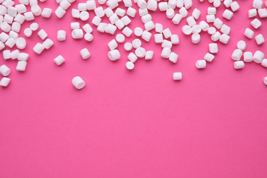 Photo of Delicious marshmallows on pink background, flat lay. Space for text