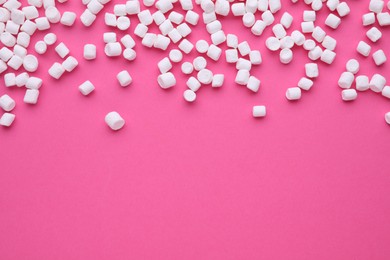 Delicious marshmallows on pink background, flat lay. Space for text