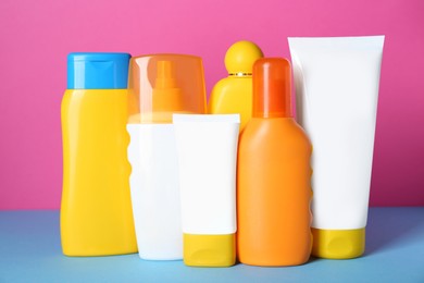Photo of Many different suntan products on color background