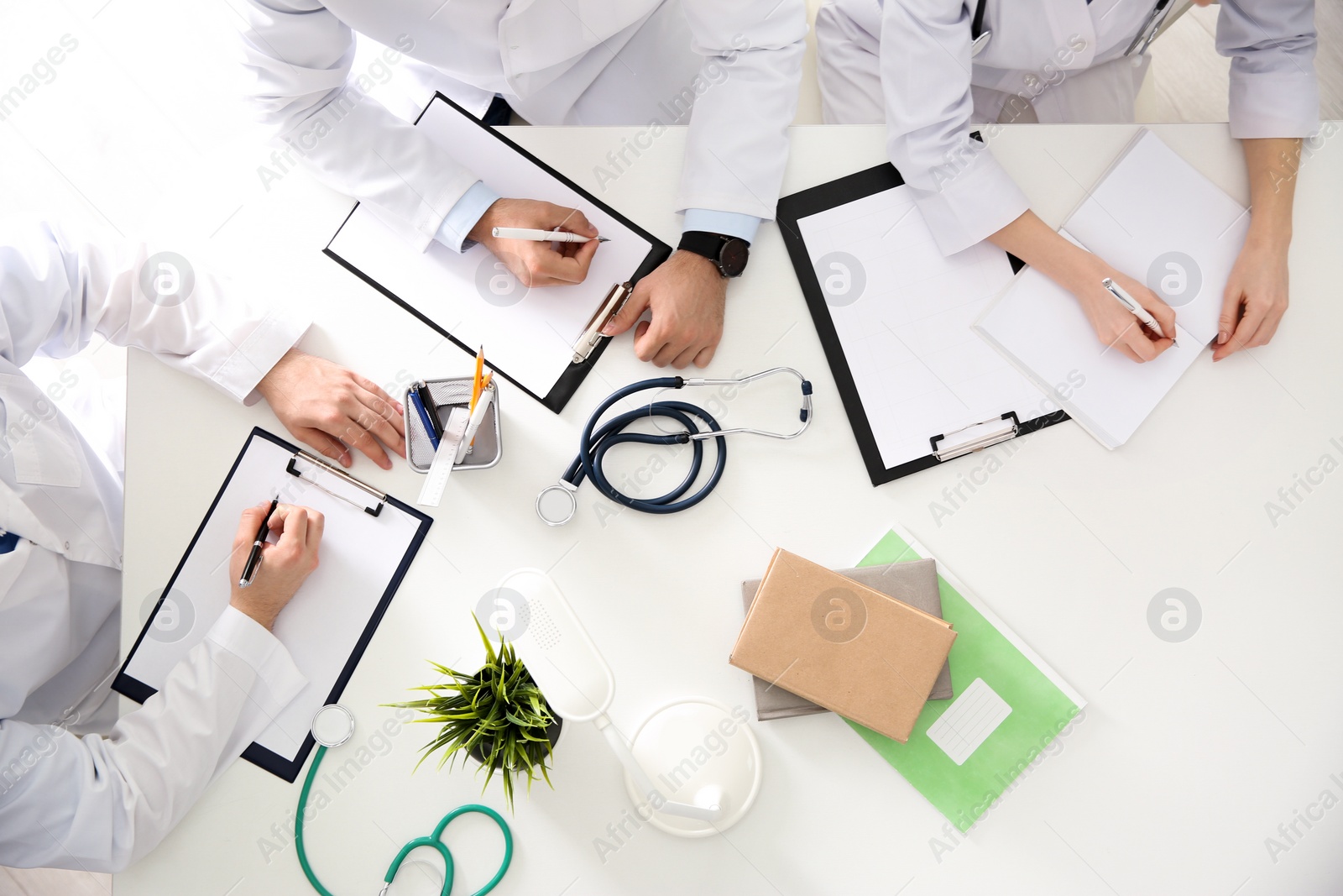 Photo of Doctors having meeting at table in office, top view